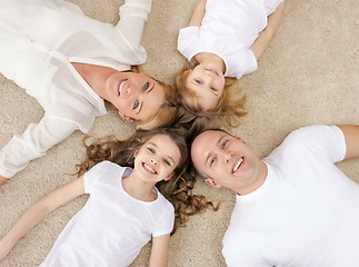 Image showing parents and two girls lying on floor at home