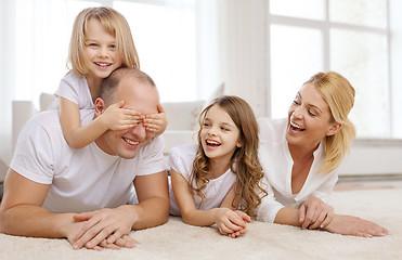 Image showing parents and two girls lying on floor at home