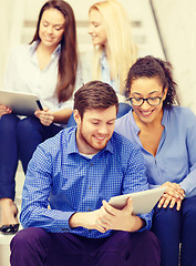 Image showing team with tablet pc computer sitting on staircase