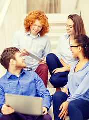 Image showing team with laptop and tablet pc on staircase