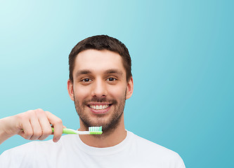 Image showing smiling young man with toothbrush