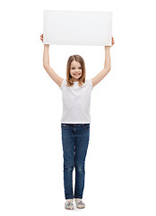 Image showing smiling little child holding blank white board