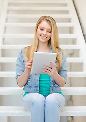 Image showing smiling female student with tablet pc computer