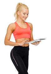 Image showing smiling sporty woman with tablet pc computer