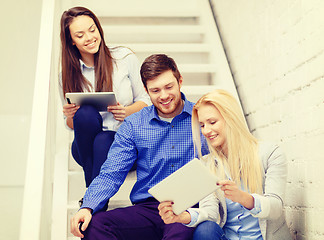 Image showing team with tablet pc computer sitting on staircase