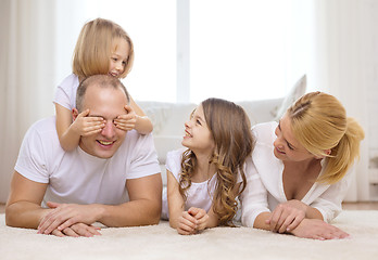 Image showing parents and two girls lying on floor at home