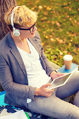 Image showing smiling male student in eyeglasses with tablet pc