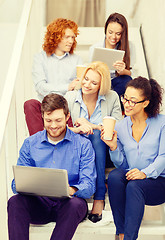 Image showing team with laptop and tablet pc on staircase