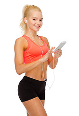 Image showing smiling sporty woman with smartphone and earphones