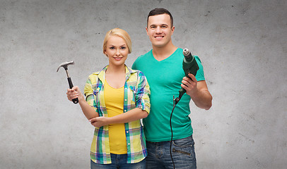 Image showing smiling couple with hammer and drill