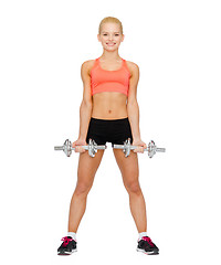 Image showing smiling sporty woman with heavy steel dumbbells