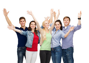 Image showing group of smiling students waving hands