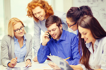 Image showing creative team with papers and clipboard at office