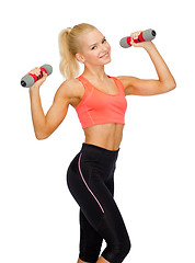 Image showing smiling beautiful sporty woman with dumbbells