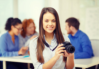 Image showing smiling female photographer with photocamera