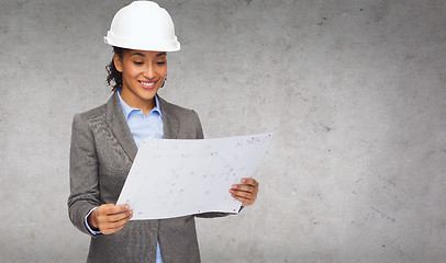 Image showing businesswoman in white helmet with blueprint