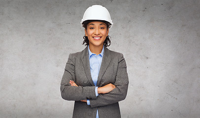 Image showing businesswoman in white helmet with crossed arms