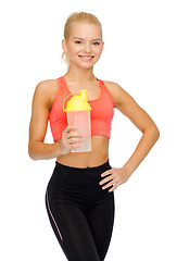 Image showing smiling sporty woman with protein shake bottle