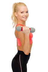 Image showing smiling beautiful sporty woman with dumbbell