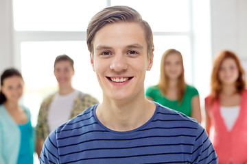 Image showing smiling students with teenage boy in front