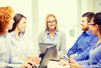 Image showing smiling team with laptop and table pc computers