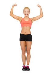 Image showing smiling sporty woman flexing her biceps