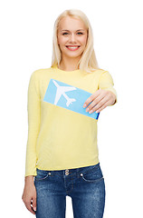 Image showing smiling young woman with airplane ticket