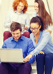 Image showing team with laptop and tablet pc on staircase