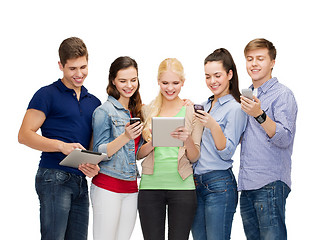 Image showing smiling students using smartphones and tablet pc