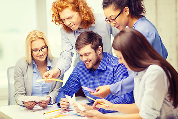 Image showing smiling team with color samples at office