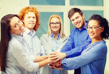 Image showing team with hands on top of each other in office