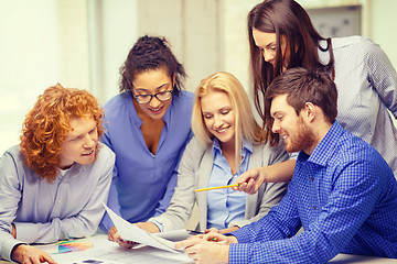 Image showing smiling team with color samples at office