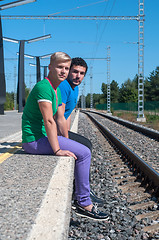 Image showing Two young men sitting on the platform
