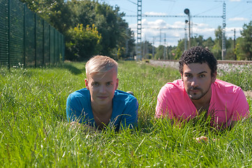 Image showing Two handsome young guys on the grass