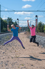 Image showing Two handsome young guys jumping