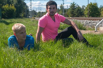 Image showing Two handsome young guys on the grass