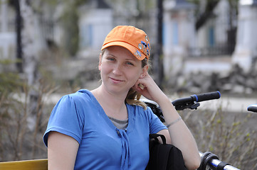 Image showing portrait of the happy woman with bicycle.