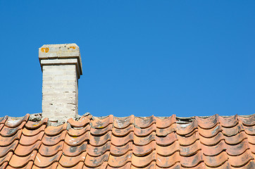 Image showing Chimney at an old broken tiled roof