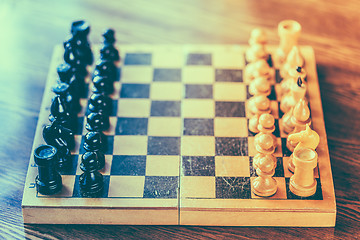 Image showing Ancient wooden chess standing on chessboard