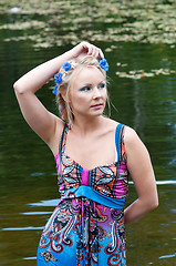 Image showing Beautiful woman in dress standing near the pond