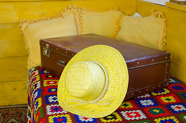 Image showing close up of summer straw women hat on old suitcase 