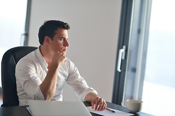 Image showing business man working on laptop computer at home