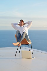 Image showing relaxed young man at home on balcony