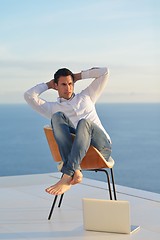 Image showing relaxed young man at home on balcony