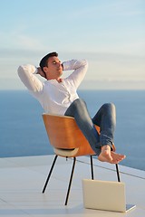 Image showing relaxed young man at home on balcony