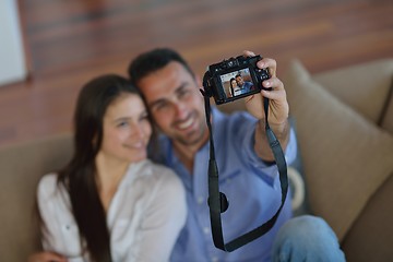 Image showing couple playing with digital camera at home