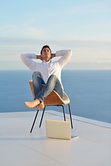 Image showing relaxed young man at home on balcony