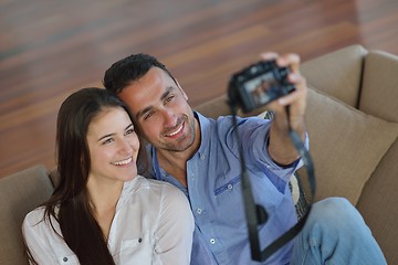 Image showing couple playing with digital camera at home