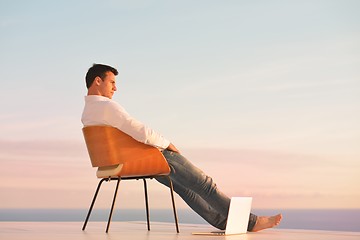 Image showing relaxed young man at home on balcony