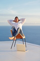 Image showing relaxed young man at home on balcony